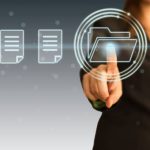 Finger touching loading file button on a touch screen